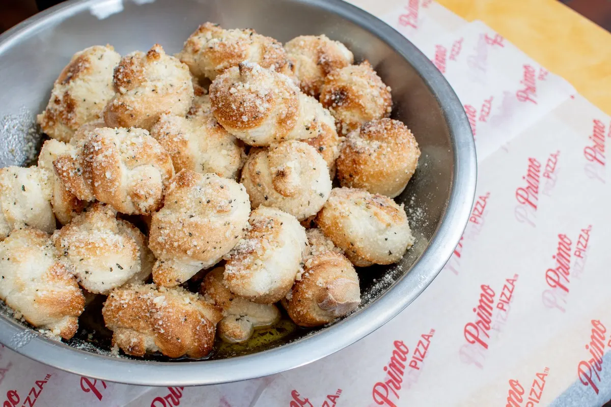A metal bowl of garlic knots